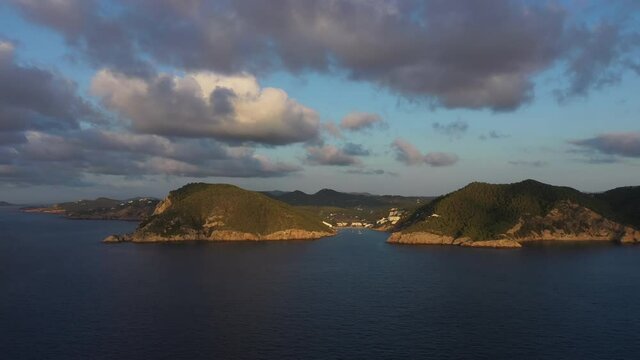 Aerial view of Cala Llonga beach, located in southern Ibiza, Spain. Beautiful aerial view of the bay at sunset