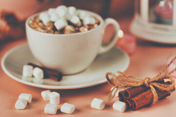 Marshmallows in a white mug with coffee, toned shot