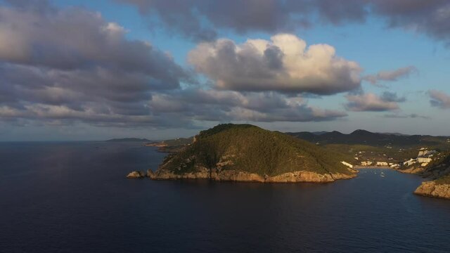 Aerial view of Cala Llonga beach, located in southern Ibiza, Spain. Beautiful aerial view of the bay at sunset