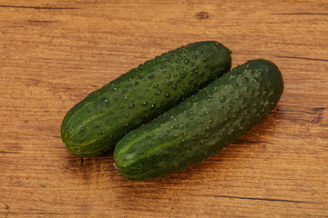Green fresh cucumbers over background