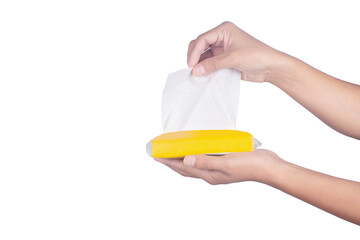 Hand holding yellow tissue pack isolated on white background.