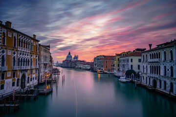 Long exposure view of Grand Canal and Basilica Santa Maria della Salute at sunset in Venice, Italy