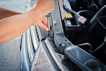 Obraz na płótnie Canvas Car service ,fitting a car with wrench 
