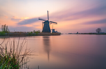 Fototapeta na wymiar Traditional dutch windmill at sunset