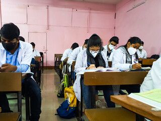 December 10, 2020. Siliguri, West Bengal India. Medical students in mask and white coat giving exam...