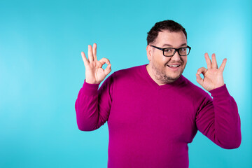 Young handsome man with beard wearing casual sweater and glasses.  Positive person. 