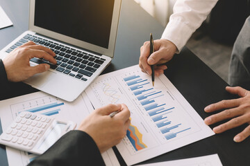 A group of professional business people sit on a meeting table in the office to discuss banking issues. Share partner A meeting idea that talks about a graph