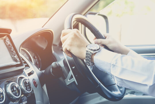 man driving car, steering wheel of a car, vintage color tone, focus at finger