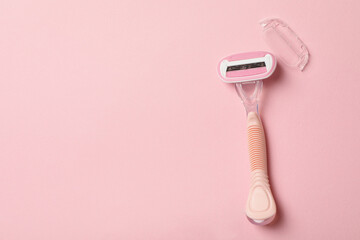 Female razor on pink background, space for text