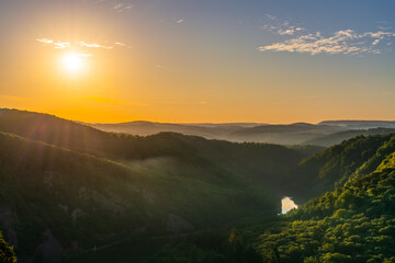 Sunrise over Saar river foggy valley near Mettlach. South Germany 