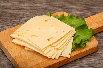 Sliced yellow cheese over board