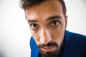 Very close looking person, head, angry and interesting looking person, funny close-up, man attracting himself.