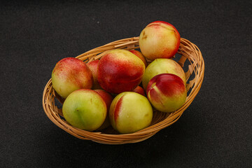 Sweet small nectarines in the basket