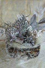 Glossy decorative headdress for the festive table in silver and white colors, richly decorated.