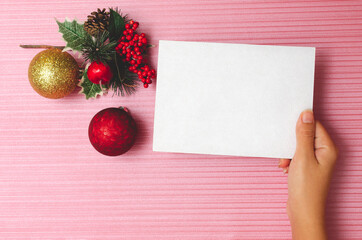 Fototapeta na wymiar Blank card with christmas decoration on textured pink background. Card mockup.