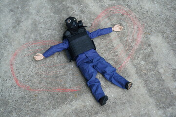Toy soldier with a gas mask on the concrete surface. On the sides of it are painted wings. Image of...
