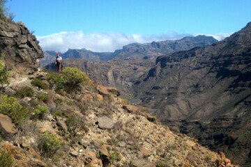 Fototapeta premium Beautiful mountain landscape during trekking around Montana de Tauro peak. Silhouette of tourist on trail. Gran Canaria, Canary Islands, Spain