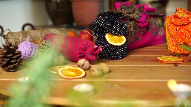 Eco-friendly green sustainability zero waste Christmas. Gift wrap by using cotton fabric and compostable natural decor. Furoshiki is a traditional Japanese cloth wrapping