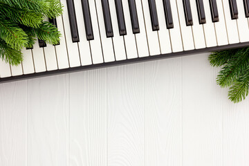 Synthesizer with Christmas decor toys and spruce branch. Christmas music.