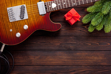 Christmas music. Flat lay composition with guitar and fir tree branches