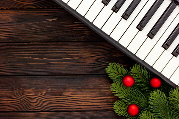 Synthesizer with Christmas decor toys and spruce branch. Christmas music.