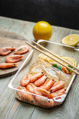 Appetizing and delicious ready made dish of shrimps and rice in a plastic container. Concept of frozen food that you can fast cooking and have dinner like in a restaurant at home