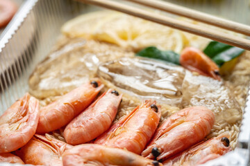 Appetizing and delicious ready made dish of shrimps and rice in a plastic container. Concept of frozen food that you can fast cooking and have dinner like in a restaurant at home. Closeup