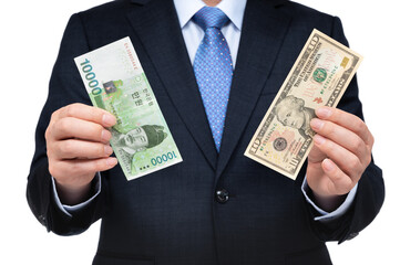 Businessman holding US dollars and Korean currency in hand.