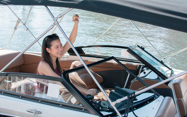 Asian woman driving speed boat