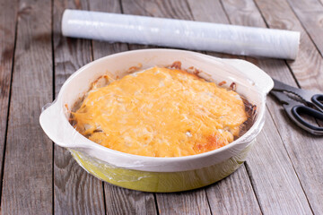 Casserole in a baking dish wrapped in a freezer foil