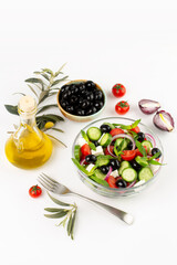 Olives and olive oil and vegetable salad in studio
