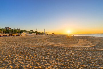 Naklejka premium Barceloneta Beach at sunrise in Barcelona, Spain