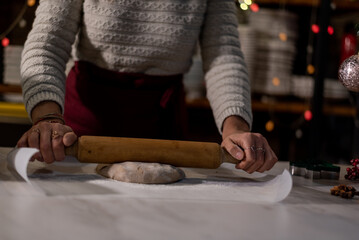 Vegan chef girl cooking sweets wearing santa hat with christmas decoration in christmas kitchen