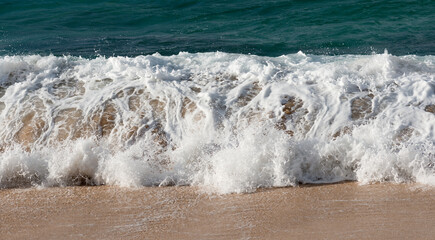 Waves breaking on the beach