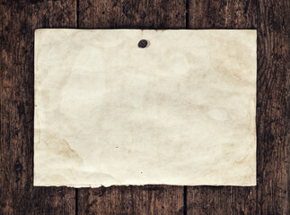 A sheet of old blank paper on a wooden board. Retro vestern style.