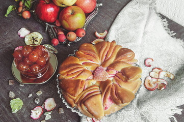 Freshly baked Apple pie with apples and homemade jam made from small apples in the background. Delicious fresh soft homemade pie