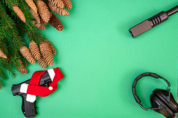 Gun, headphones on a green background. Christmas concept.