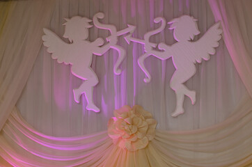 Decoration, two large angels, cupids, hanging on the wall in the Banquet hall