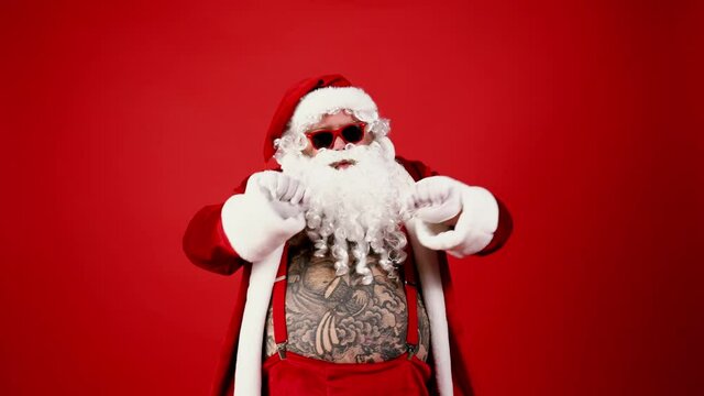 Crazy modern santa claus version with tattoos celebrating on christmas. 