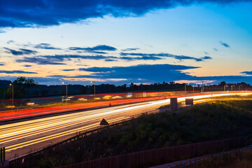 Traffic light trails on M1 motorway at dusk