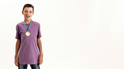 Portrait of happy teenaged disabled boy with cerebral palsy wearing gold medal, smiling at camera...