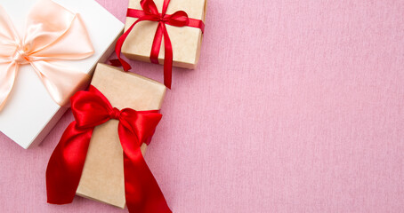 gift boxes with ribbons on pink background, banner