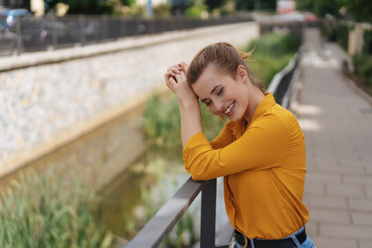 Cute happy young woman smiling to herself