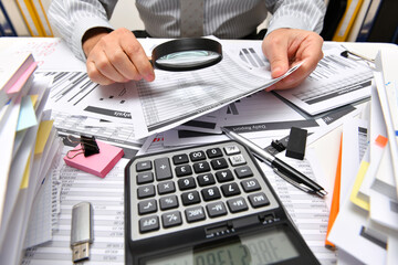 business concept - businessman working with reports in office, table and workspace close view, analyzing financial data, writes and counts