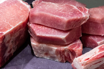 Chopped meat on a kitchen cutting board. Pork with a layer of lard.