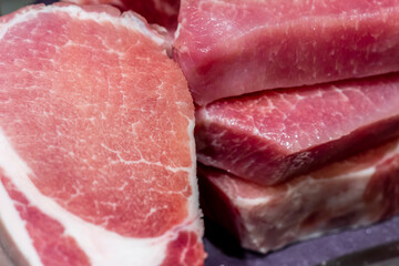 Chopped meat on a kitchen cutting board. Pork with a layer of lard.