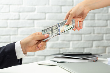 Man in suit give money to woman