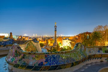 Fotobehang Barcelona Barcelona at night seen from Park Guell. Park was built from 1900 to 1914 and was officially opened as a public park in 1926. In 1984, UNESCO declared the park a World Heritage Site  © Pawel Pajor