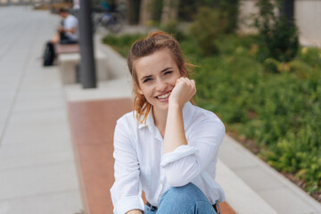 Genuine young woman looking at camera smiling