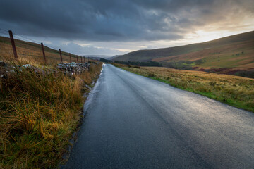 Sunset over the old road that follows the River Tawe and ends in Trecastle in South Wales UK
